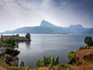 Uksan Lake in Lonavala surrounded by lush greenery and calm waters under a clear sky